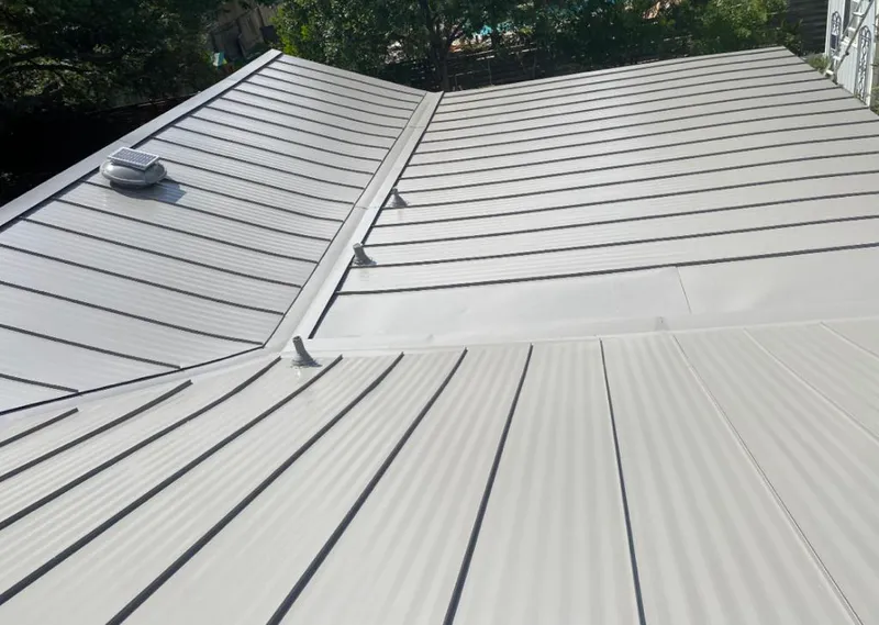 Solar attic fan installed on a metal roof for Roof Ventilation in Island Park