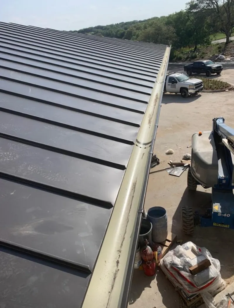 Standing seam panel and gutter detail on a metal roofing jobsite in Island Park